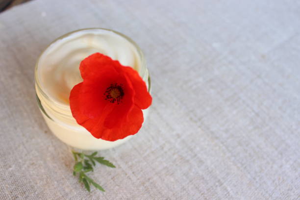 cosmetic cream with poppy flower - plastic poppy imagens e fotografias de stock