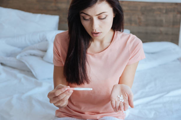 istock Young girl scared by pregnancy test results 698105702