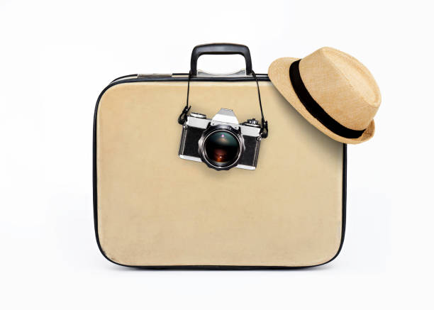 holiday travelling holiday equipments in front of a luggage photographic film camera stock pictures, royalty-free photos & images