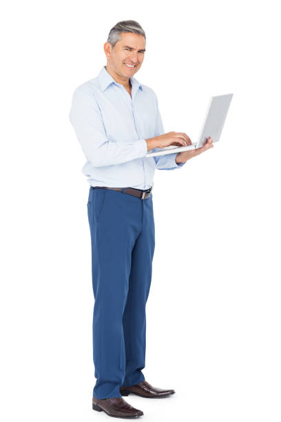 istock Smiling businessman typing on laptop 698108096