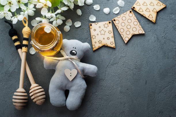 istock Honey with blossoms and wooden spoons 698114344