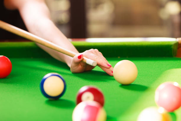 istock Close up on girl hand playing billiard. 698117312