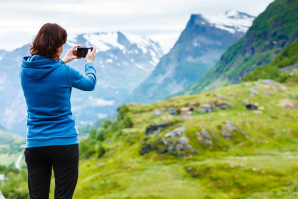 istock Tourist taking photo in mountains Norway 698120906