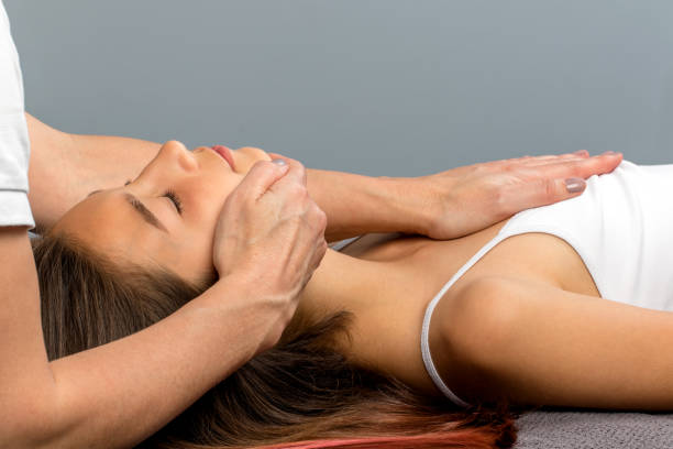 istock Hands doing physical neck treatment on child. 698121030