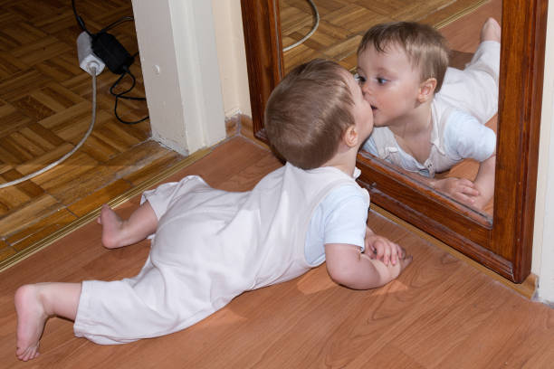 istock Baby boy kiss in mirror 698124048