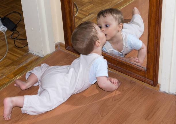 istock Baby boy kiss in mirror 698124062
