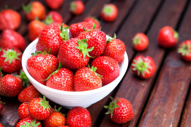 istock Strawberries on wooden background. Copy space 698126726