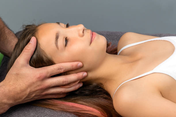 istock Hands doing healing  physical cranial therapy on child. 698126858