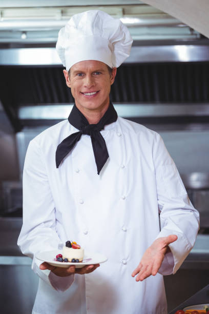 istock Proud chef holding a plate of cheesecake desert 698127034