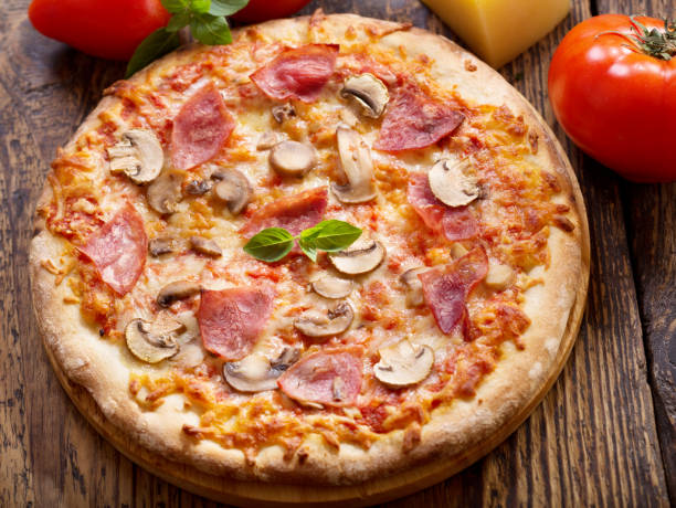 istock pizza with ham, salami and mushrooms 698127128