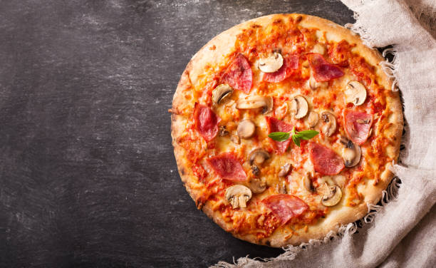 istock pizza with ham, salami and mushrooms 698127134