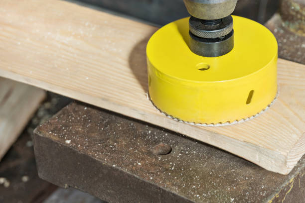 Cutting the board with a core bit Drilling a large hole in the board with a core drill on a vertical drilling machine boreray and stac lee stock pictures, royalty-free photos & images