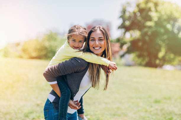 istock Mother and daughter playing outdoors 698131428