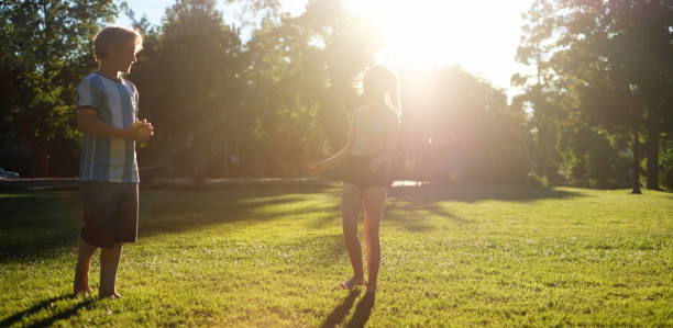 istock Boy and girl playing in park 698131640