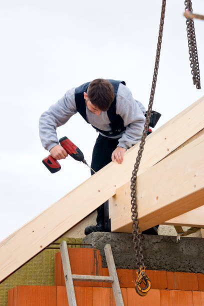 istock Young carpenter connecting roof beams 698132380