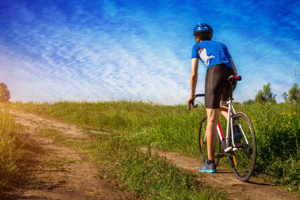 istock Young bicyclist riding in the field 698138556