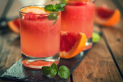 Palomas cocktail combines tequila,mint,fresh grapefruit juice, lime juice,ice,sugar,salt and club soda with a grapefruit wedge.