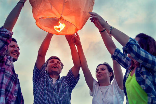 istock Group of young friends floating on a Chinese lantern 698142510