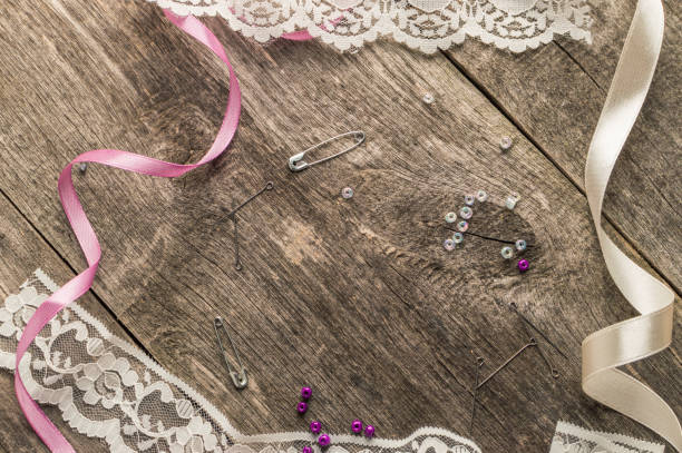 istock Lace, beads, sewing supplies on wooden background. Top view. Flat lay composition 698151940