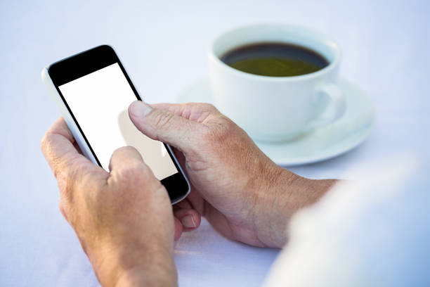 istock Casual businessman using smartphone and having coffee 698153410