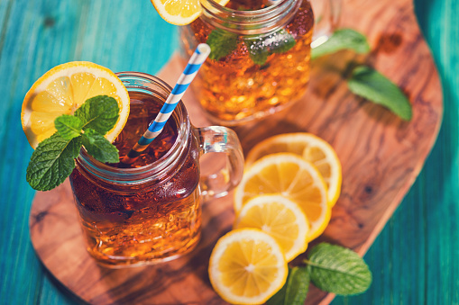 Freshly made ice tea with lemon and mint in a jar