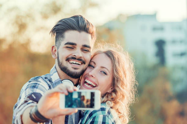 istock Happy young couple having fun outdoors and smiling 698178660