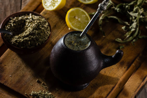 istock Latin American hot drink herb tea - Yerba mate in clay mug 698189496