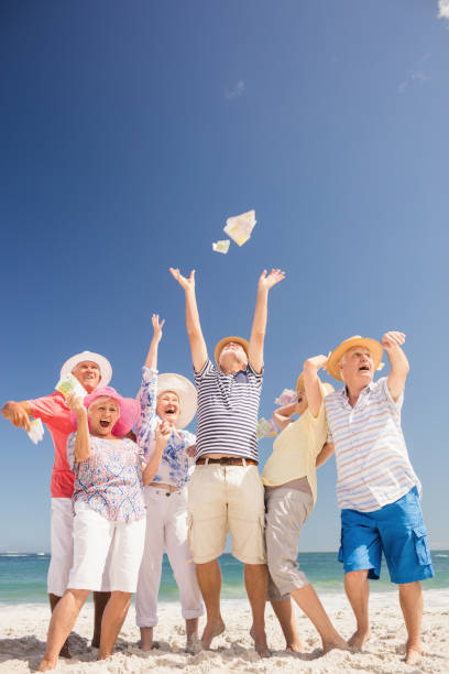 istock Happy senior throwing money 698189556