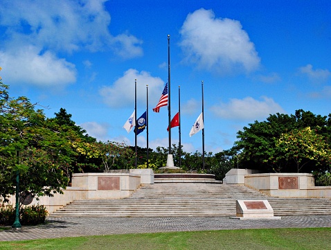 US and military flags at half staff at the Court of Honor at American Memorial Park, Saipan