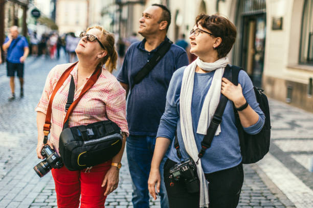 istock Three friends walking on a cobblestone street in Prague's Old town. 698190356