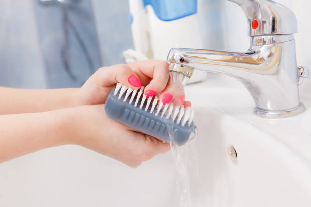 istock Woman washing her hands in sink 698196408
