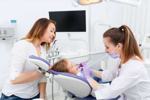 istock Dentists making treatment for little girl 698211730