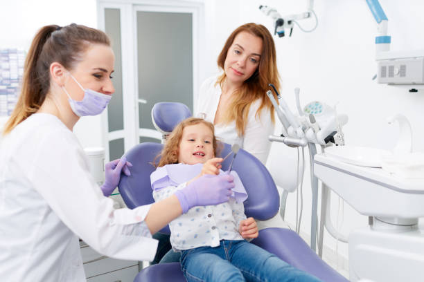 istock Dentists examining little girl 698212052