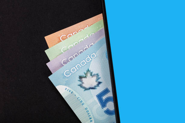 istock Canadian dollar and cellphone 698216988