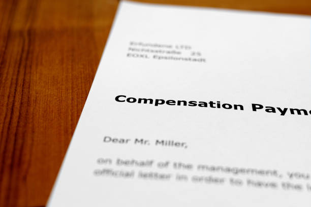 istock A letter on a wooden desk -  compensation payment 698217196
