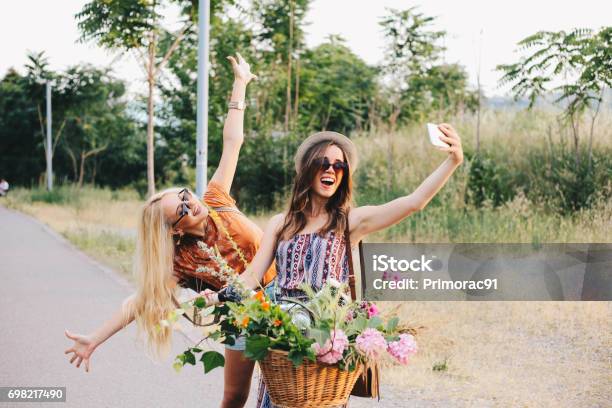 Girl Friends Are Taking Selfie On A Bike Stock Photo - Download Image Now - Flower, Teenage Girls, Friendship