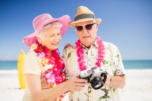 istock Senior couple holding camera 698221292