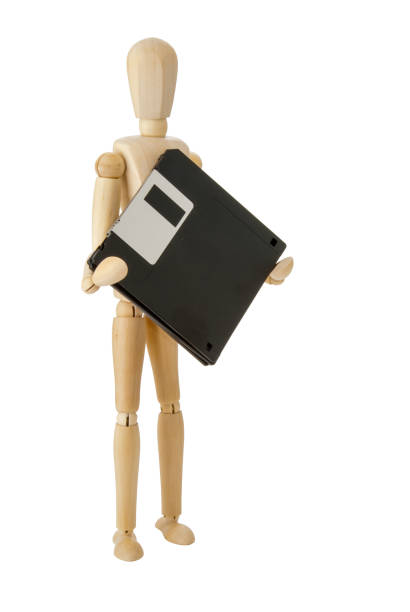 istock Wooden doll with 3.5 inch flopppies 698223790