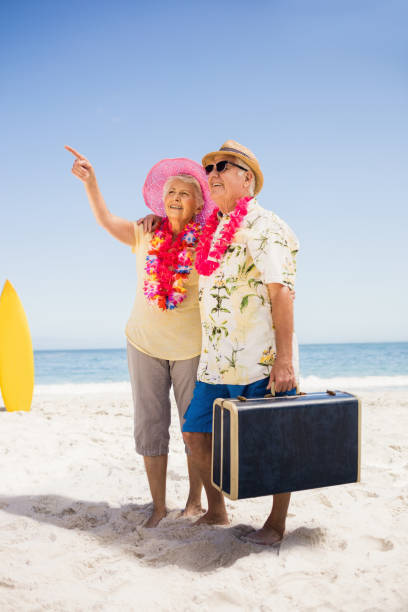istock Senior couple holding suitcase 698224170
