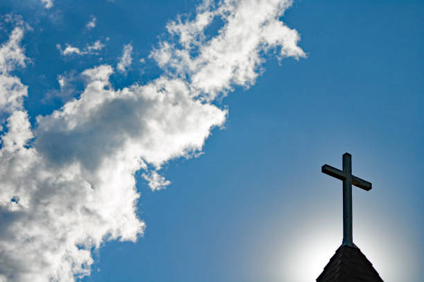 istock Church steeple and cross with clouds   copy space 698238562