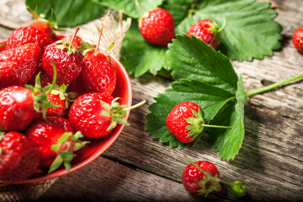 istock Fresh Strawberry in a Bowl on a wooden table background. 698271622