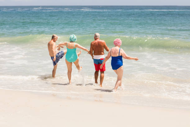 istock Senior friends playing in water 698273398