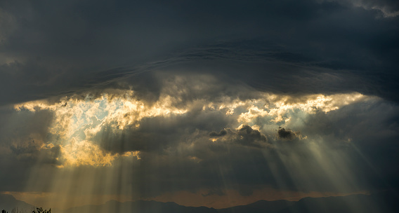 Low angle view of storm clouds on the sky with sumbeams.  Horizontal composition. Image taken with Nikon D800 and developed from Raw format.