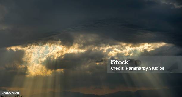 Low Angle View Of Storm Clouds On The Sky With Sumbeams Stock Photo - Download Image Now