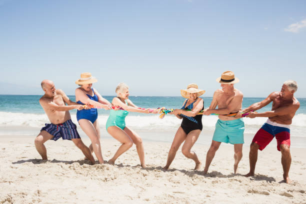 istock Senior friends playing tug of war 698280190