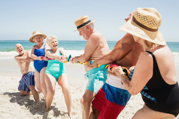 istock Senior friends playing tug of war 698280284