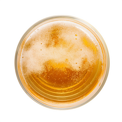 Top view of amber colored beer with foam and bubbles in simple glass. Isolated on white with clipping path