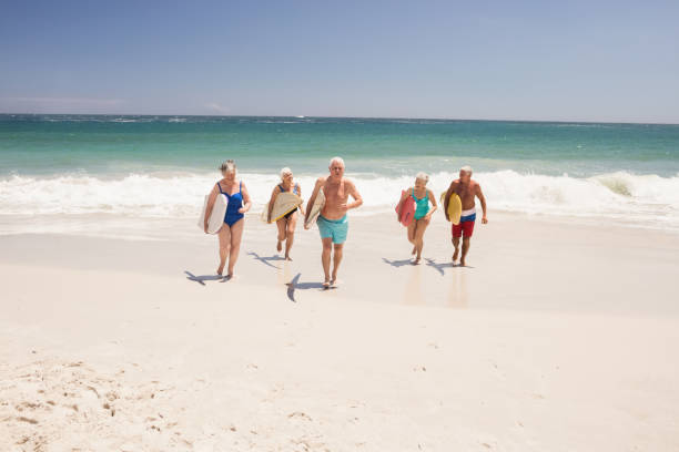 istock Senior friends holding surfboard 698315132