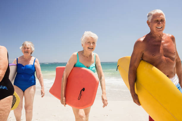 istock Senior friends holding surfboard 698315240