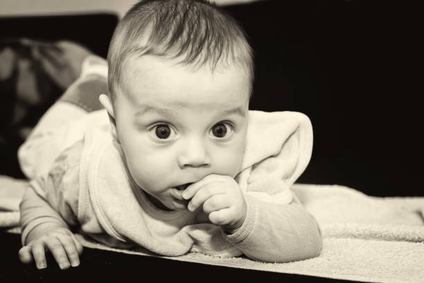 istock Baby boy on bed 698318644